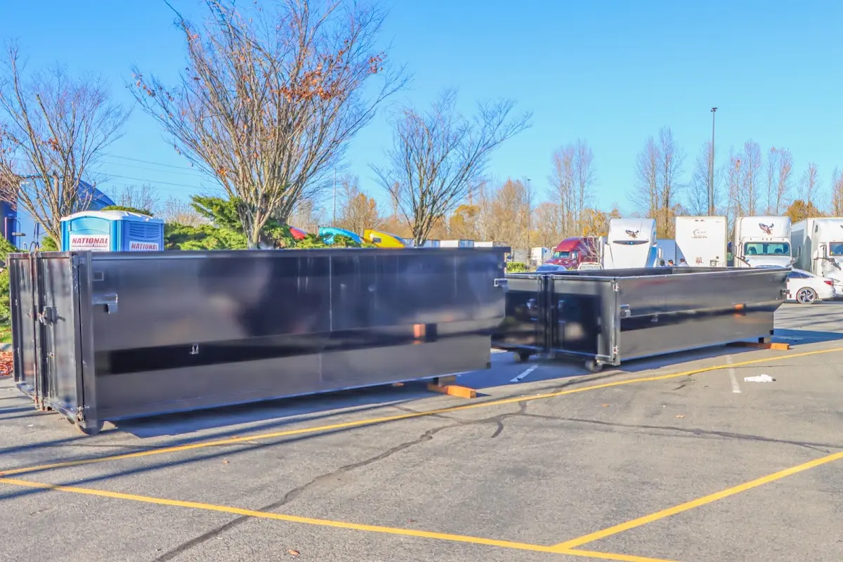 Professional dumpster rental service with roll-off container on residential driveway in Roxboro